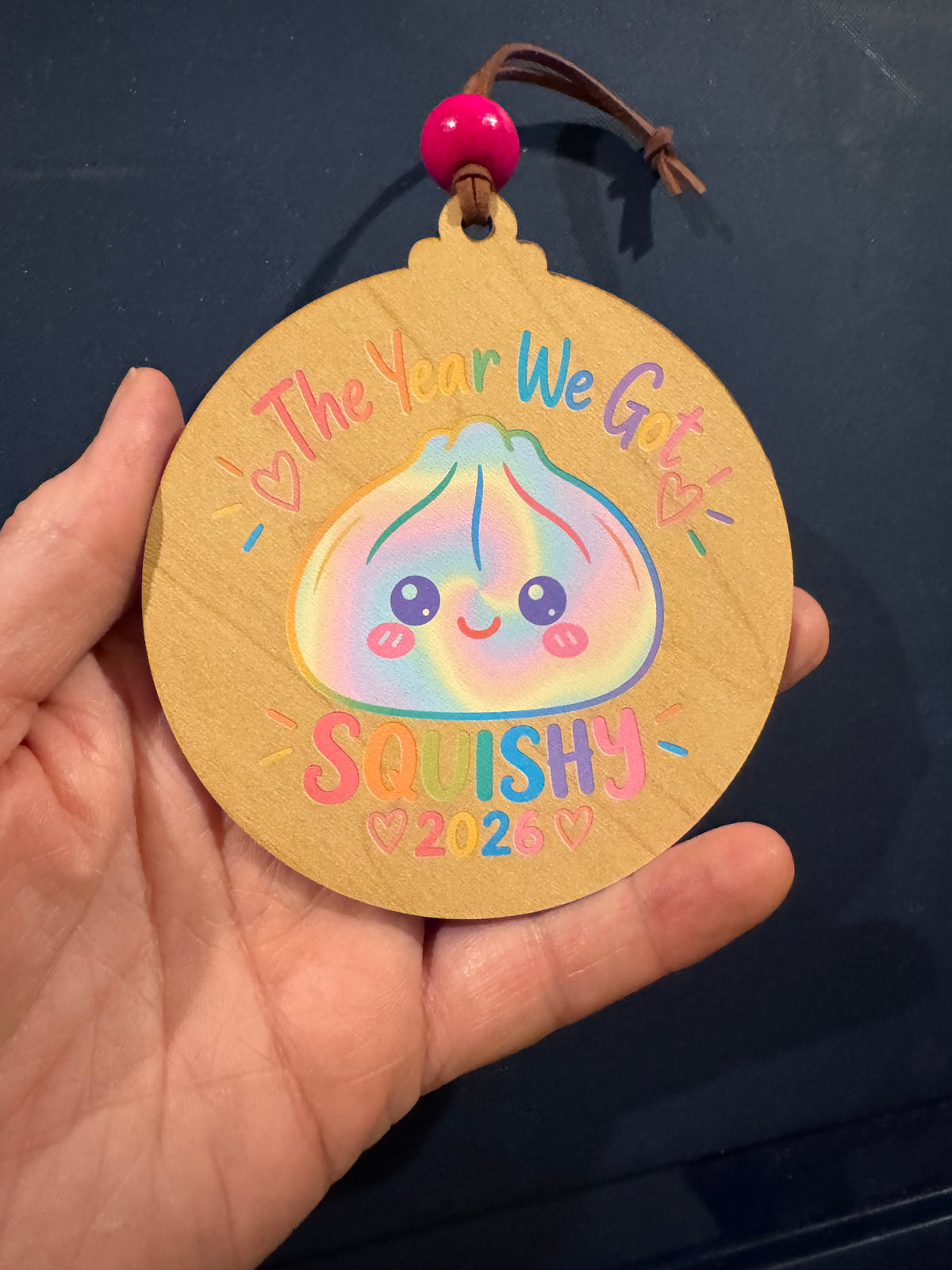Squishy 2026 Ornament – Pastel Rainbow Wood Design