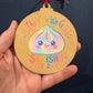 Squishy 2026 Ornament – Pastel Rainbow Wood Design