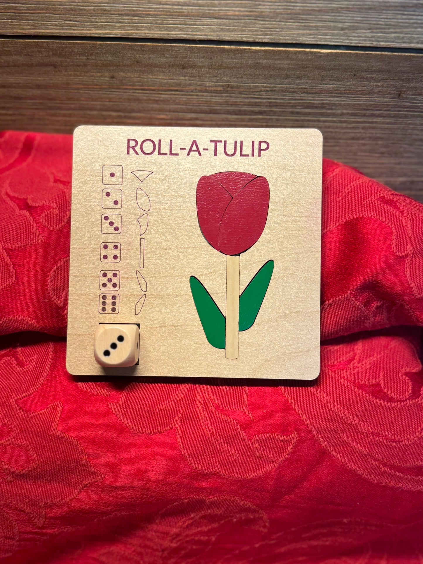 Roll-A-Tulip wooden dice game with a vibrant red tulip design, ideal for craft-loving kids and adults